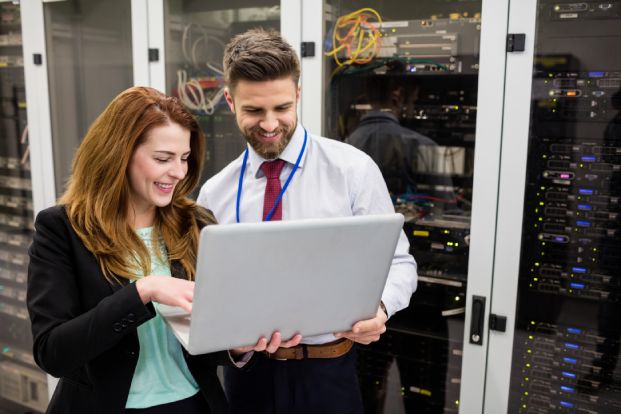 technicians-using-laptop-while-analyzing-server